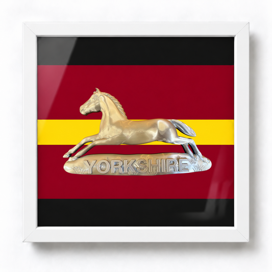 Framed Prince of Wales's Own Regiment of Yorkshire silver cap badge with printed regimental presentation backing