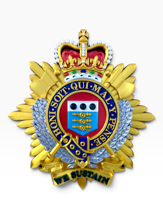 Front view of the Royal Logistic Corps Queen's Crown cap badge with gold rays, a silver wreath and WE SUSTAIN scroll