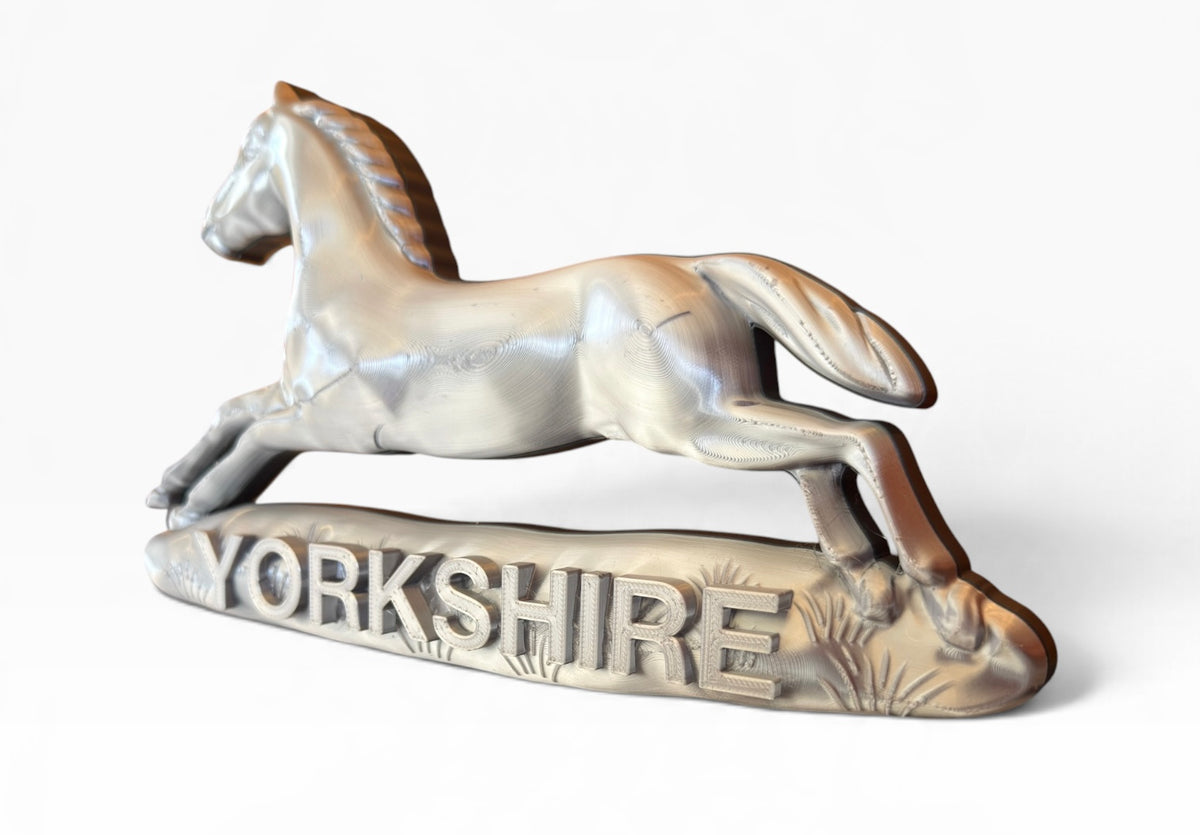 White Horse of Hanover design on the Prince of Wales's Own Regiment of Yorkshire military cap badge display